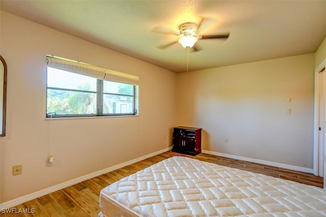 unfurnished bedroom featuring ceiling fan and light hardwood / wood-style flooring