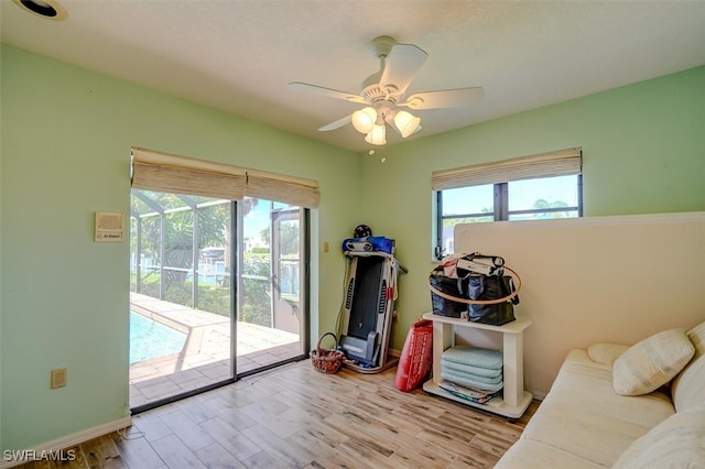 rec room with light wood-type flooring and ceiling fan