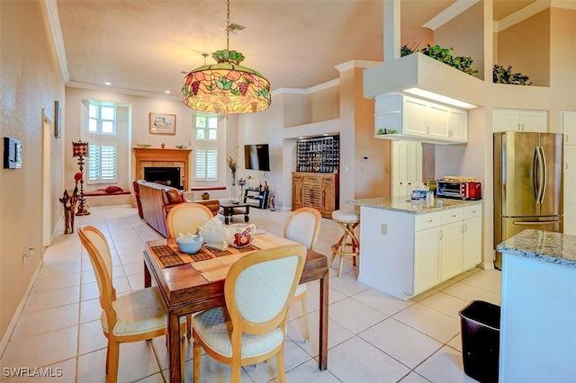 tiled dining area featuring ornamental molding