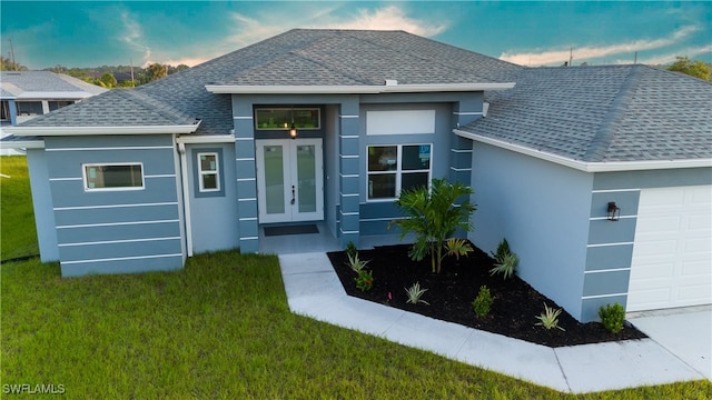 exterior entry at dusk with a yard and a garage