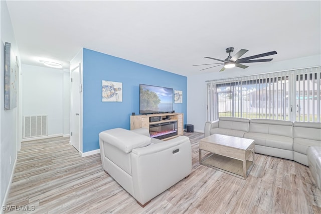 living room featuring ceiling fan and light wood-type flooring