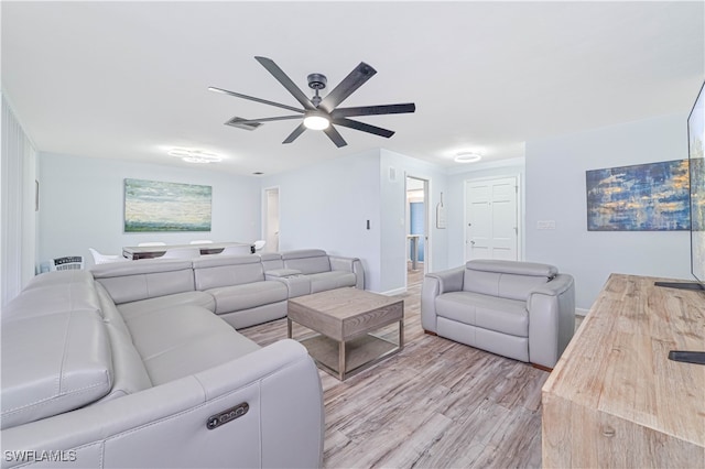 living room featuring light wood-type flooring and ceiling fan