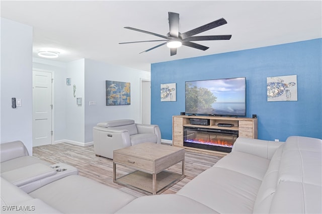 living room with wood-type flooring and ceiling fan