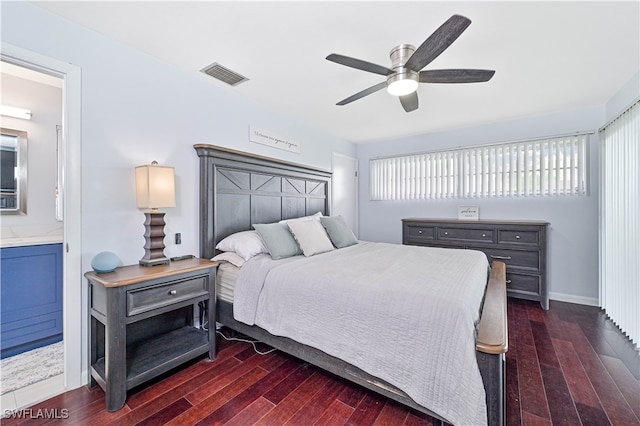 bedroom featuring ceiling fan, ensuite bathroom, and dark wood-type flooring