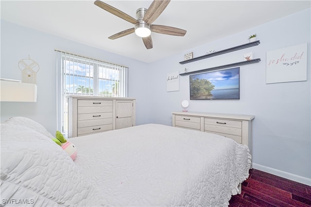 bedroom with ceiling fan and dark hardwood / wood-style floors