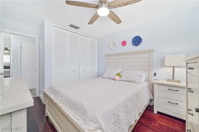 bedroom with ceiling fan, a closet, and dark wood-type flooring