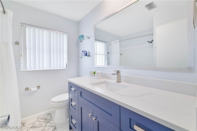 bathroom with walk in shower, vanity, and toilet