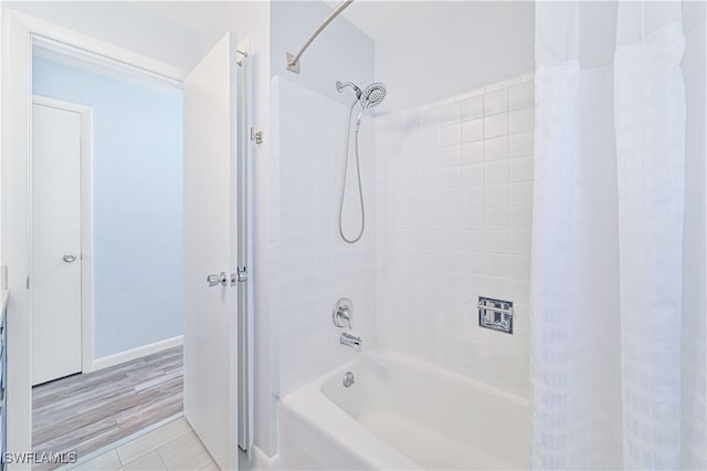 bathroom with shower / bath combo with shower curtain and hardwood / wood-style floors