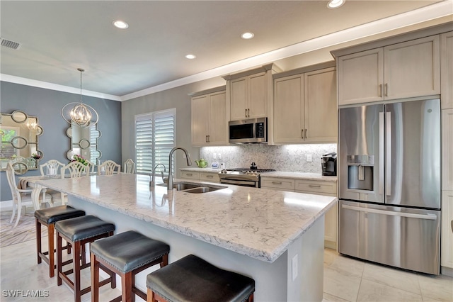 kitchen featuring an island with sink, appliances with stainless steel finishes, and sink