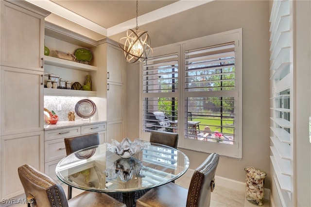 dining area featuring a chandelier and light tile patterned flooring