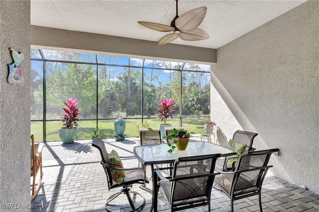 sunroom featuring ceiling fan and a wealth of natural light