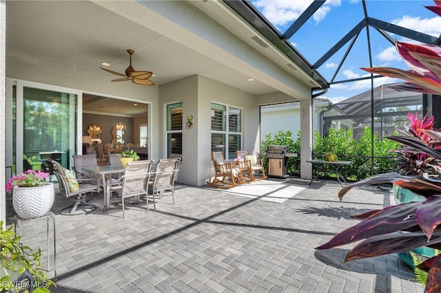 view of patio / terrace with glass enclosure and ceiling fan