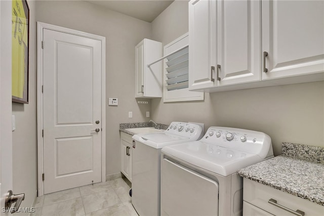 washroom featuring separate washer and dryer, cabinets, and sink