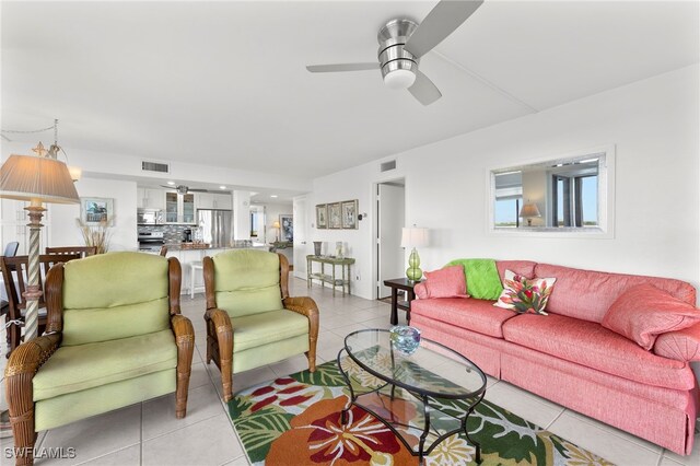 living room with ceiling fan and light tile patterned floors