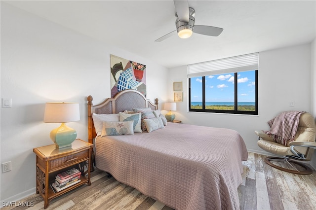 bedroom with light hardwood / wood-style floors and ceiling fan