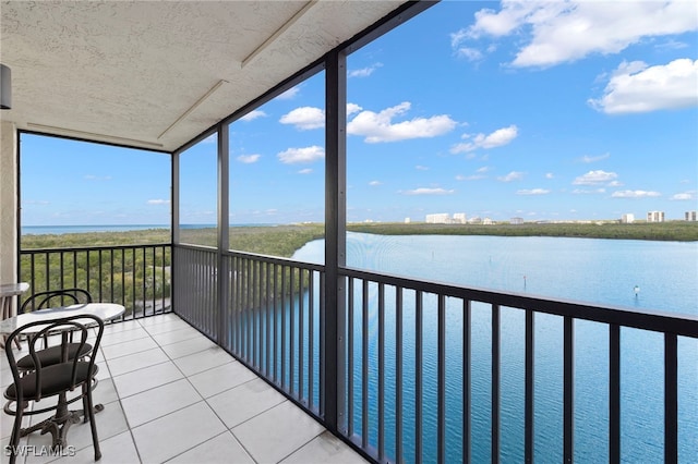 sunroom with a water view and a healthy amount of sunlight