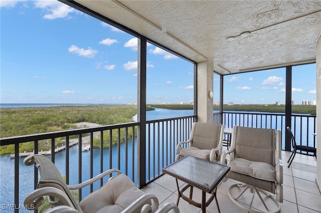 sunroom / solarium featuring a water view