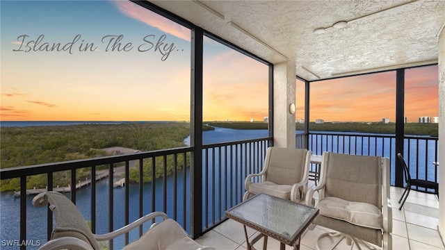 sunroom / solarium with a water view