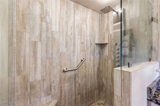 bathroom with tiled shower