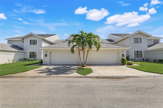 front of property featuring a front yard and a garage