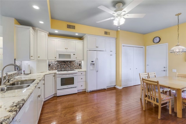 kitchen with white cabinetry, white appliances, sink, and dark hardwood / wood-style flooring