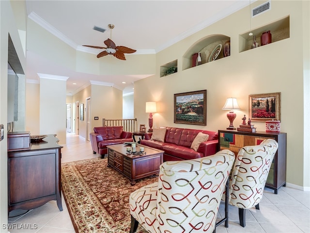 living room with ornamental molding, a towering ceiling, and ceiling fan