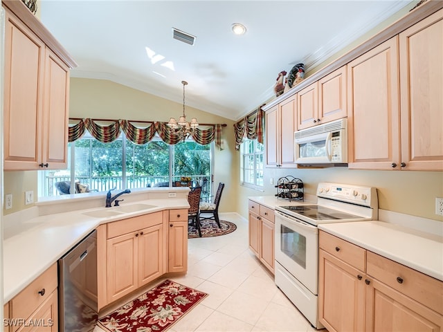 kitchen featuring light brown cabinets, lofted ceiling, sink, and white appliances