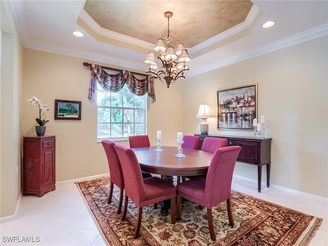 dining area featuring ornamental molding, a raised ceiling, and an inviting chandelier