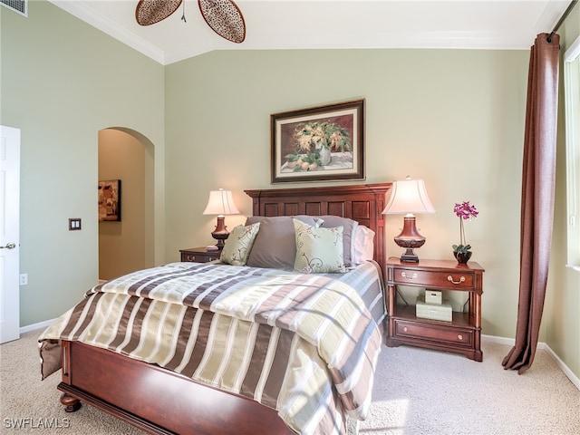 carpeted bedroom featuring ornamental molding, vaulted ceiling, and ceiling fan