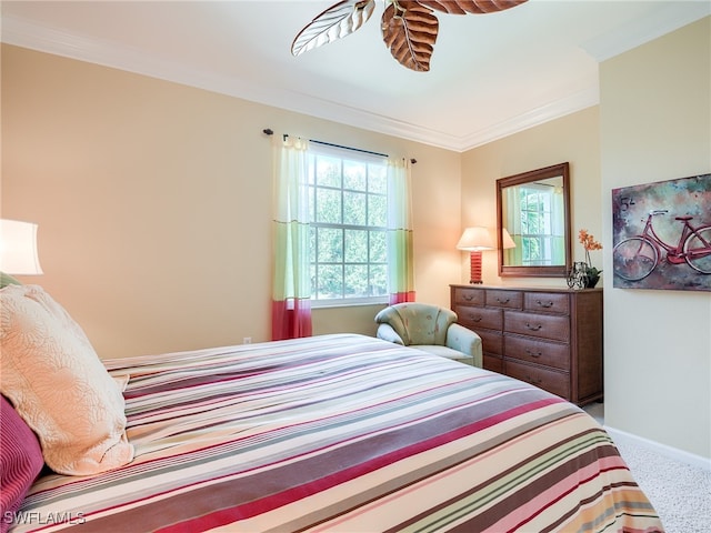 bedroom with carpet floors and crown molding