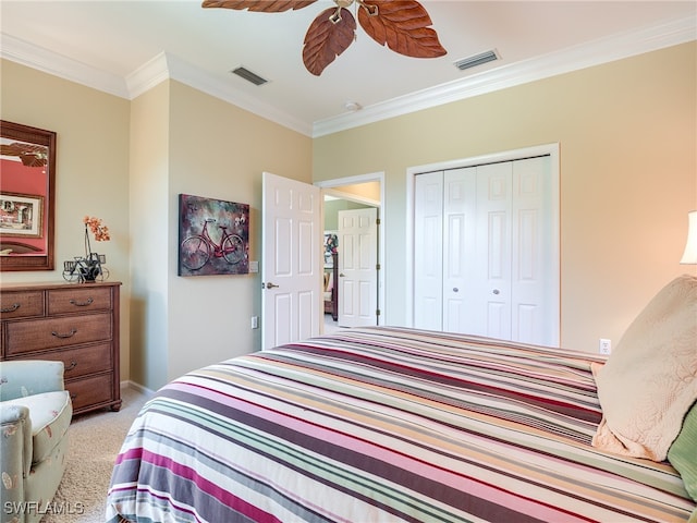 bedroom with light carpet, ceiling fan, a closet, and ornamental molding