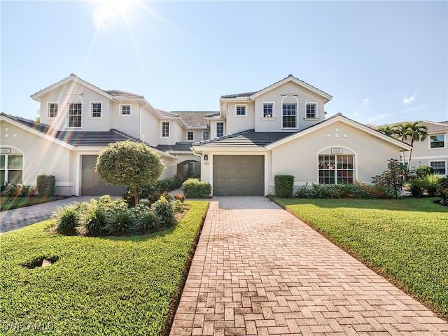 front facade featuring a front yard and a garage