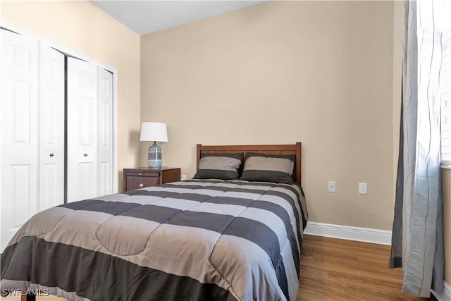 bedroom with hardwood / wood-style flooring and a closet