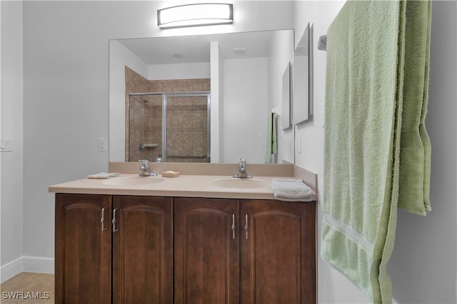 bathroom featuring walk in shower and vanity