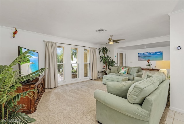 living room with ceiling fan, light colored carpet, and ornamental molding