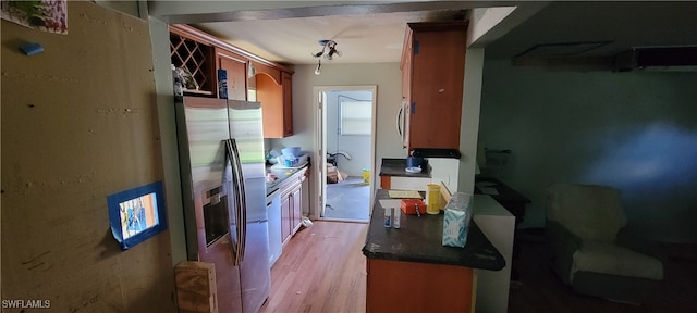 kitchen with light hardwood / wood-style flooring and stainless steel fridge