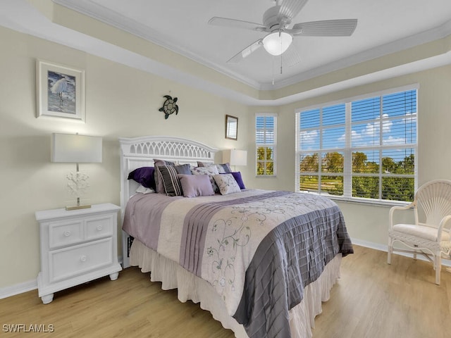 bedroom with multiple windows, light hardwood / wood-style floors, ornamental molding, and ceiling fan