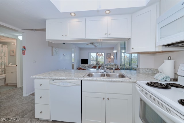 kitchen featuring light tile patterned flooring, white cabinetry, sink, kitchen peninsula, and white appliances