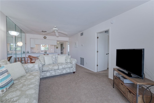 carpeted living room with ceiling fan