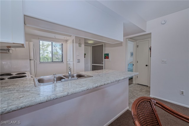 kitchen featuring white cabinets, white range, sink, and light tile patterned floors