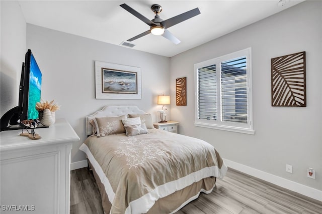 bedroom featuring ceiling fan and light hardwood / wood-style flooring