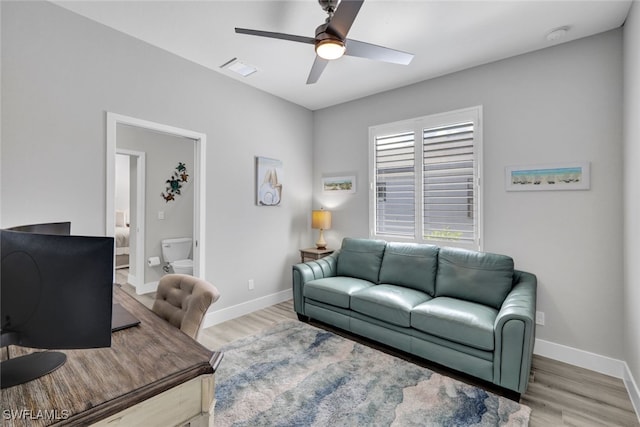 living room with wood-type flooring and ceiling fan