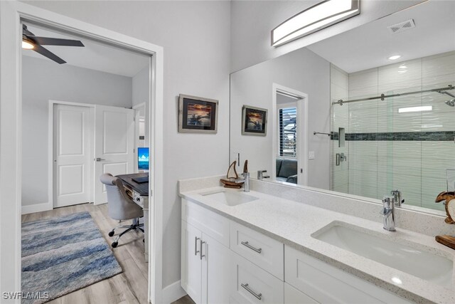 bathroom with vanity, ceiling fan, wood-type flooring, and an enclosed shower