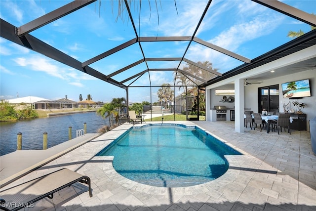 view of swimming pool with a grill, a water view, a patio area, glass enclosure, and ceiling fan