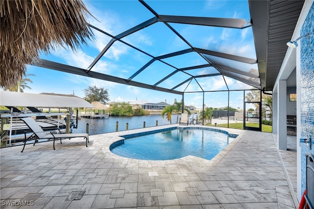 view of swimming pool with a patio, a water view, and a lanai