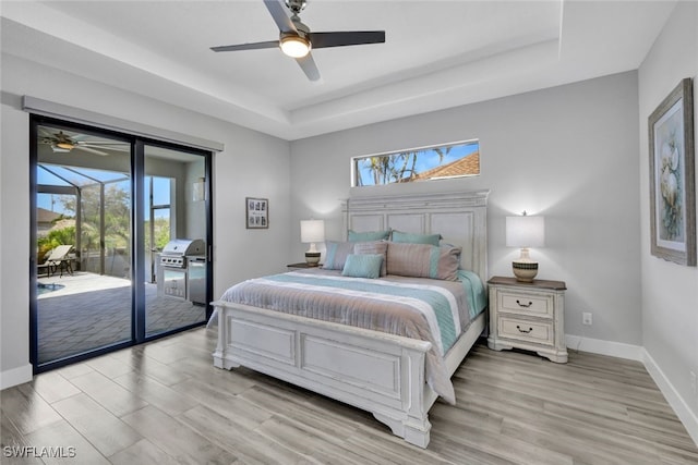 bedroom with multiple windows, access to exterior, light wood-type flooring, and ceiling fan