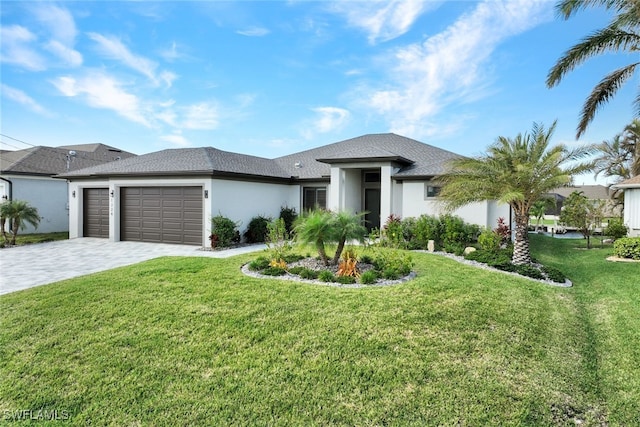 view of front of home featuring a front lawn and a garage