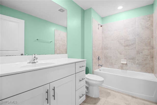 full bathroom with tiled shower / bath combo, tile patterned floors, vanity, and toilet