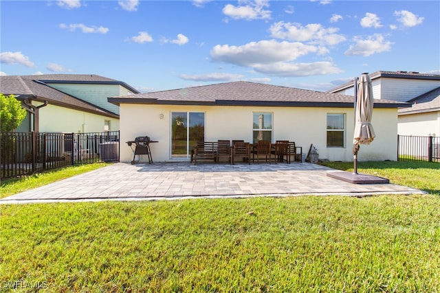 back of house featuring a lawn and a patio area