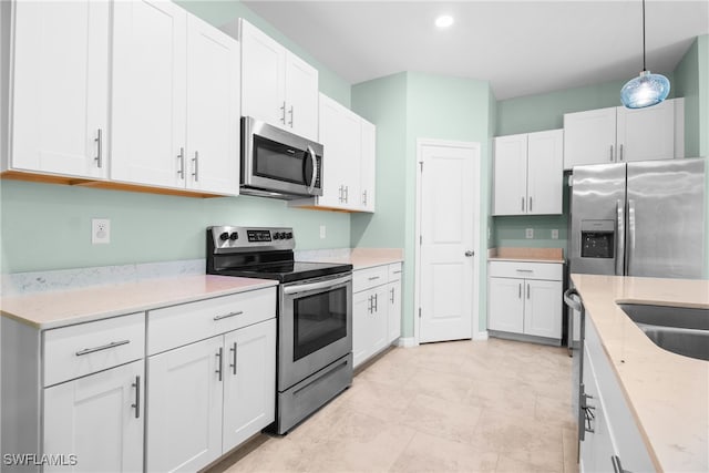 kitchen with white cabinets and appliances with stainless steel finishes